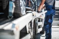 Worker Securing Car on a Towing Truck