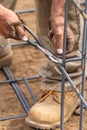 Worker Securing Steel Rebar Framing With Wire Plier Cutter Tool