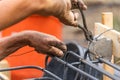 Worker Securing Steel Rebar Framing With Wire Plier Cutter Tool