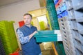 Worker selecting color coded plastic crate