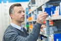 worker selecting package from racking in storeroom