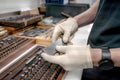 The worker selects gauge blocks to obtain the required control size of the part being manufactured and adjusts the measuring tool Royalty Free Stock Photo