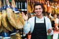 Worker selling Spanish jamon