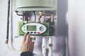 Worker set up central gas heating boiler at home Royalty Free Stock Photo