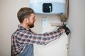 worker set up central gas heating boiler at home Royalty Free Stock Photo