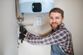 worker set up central gas heating boiler at home Royalty Free Stock Photo