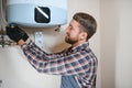 worker set up central gas heating boiler at home Royalty Free Stock Photo