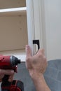 worker sets handles for kitchen cabinets