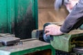 The worker sets the metal workpiece in a vice for processing on a CNC milling machine Royalty Free Stock Photo