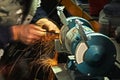 Man sharpening tool instrument on a grinder with sparks Royalty Free Stock Photo
