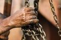 Worker at a shipyard in Dhaka Bangladesh holds a chain with his hands