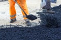 Worker with shovel on asphalt Royalty Free Stock Photo