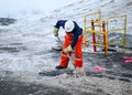 Worker shovelling snow near open manhole Royalty Free Stock Photo