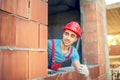 Worker showing ok hand sign on construction site. Building engineer with quality control approving construction Royalty Free Stock Photo