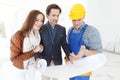 Worker shows house design plans Royalty Free Stock Photo