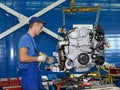 The worker on a site of subassembly of automobile engines. Assembly shop of automobile plant Royalty Free Stock Photo