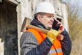 Worker with sledge hammer talking on cell phone Royalty Free Stock Photo