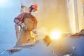 Worker with sledgehammer at indoor wall destroying Royalty Free Stock Photo