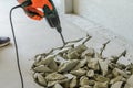 Worker smashes concrete floor with electric hammer drill Royalty Free Stock Photo