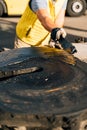 A worker smearing trailer fifth wheel coupling with lubricant oil. Semi-truck mechanical maintenance Royalty Free Stock Photo