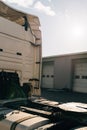 A worker smearing trailer fifth wheel coupling with lubricant oil. Semi-truck mechanical maintenance Royalty Free Stock Photo