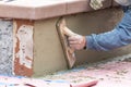 Worker Smoothing Cement with Wooden Float At Construction Site Royalty Free Stock Photo