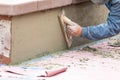 Worker Smoothing Cement with Wooden Float At Construction Site Royalty Free Stock Photo