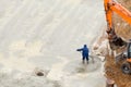 Worker smoothing concrete by trowel to finish concrete floor. Royalty Free Stock Photo