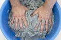 Worker soaks and mixes silk plaster.