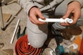 The worker soldered two tubes to heat the floor with a soldering iron Royalty Free Stock Photo