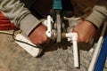 The worker soldered two tubes to heat the floor with a soldering iron Royalty Free Stock Photo