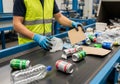 Worker sorting recyclable items on conveyor belt in modern facility Royalty Free Stock Photo