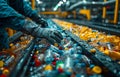 Worker sorts plastic bottles on conveyor belt at recycling facility. Royalty Free Stock Photo