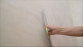 Worker spackles the walls with a spatula. Spatula with putty in hand. Worker puts of plaster on wall. Royalty Free Stock Photo