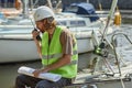 Worker speaking to radio in yacht docks