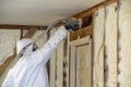 Worker spraying closed cell spray foam insulation on a home wall Royalty Free Stock Photo