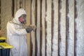 Worker spraying closed cell spray foam insulation on a home wall Royalty Free Stock Photo