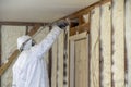 Worker spraying closed cell spray foam insulation on a home Royalty Free Stock Photo