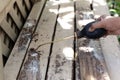 Worker Spraying Insecticide Chemical For Termite Pest Control on wooden deck. Royalty Free Stock Photo