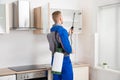 Worker Spraying Insecticide On Shelf Royalty Free Stock Photo