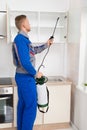 Worker Spraying Insecticide On Shelf Royalty Free Stock Photo