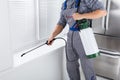 Worker Spraying Insecticide On Windowsill Royalty Free Stock Photo