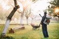 worker spraying organic pesticides for garden treatment