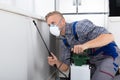 Worker Spraying Pesticide On Wall Royalty Free Stock Photo