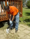 Worker Spraying Weed Killer On A Customers Patio Royalty Free Stock Photo