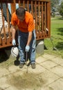 Worker Spraying Weed Killer On A Old Patio Royalty Free Stock Photo