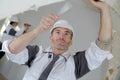worker spreading plaster on ceiling at construction site Royalty Free Stock Photo