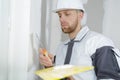 Worker spreading plaster to wal Royalty Free Stock Photo
