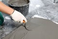 Worker spreading wet concrete with trowel indoors, closeup Royalty Free Stock Photo