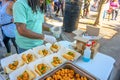 Worker Sprinkles Cilantro on Shrimp Poboy Sandwiches at Poboy Fest in New Orleans